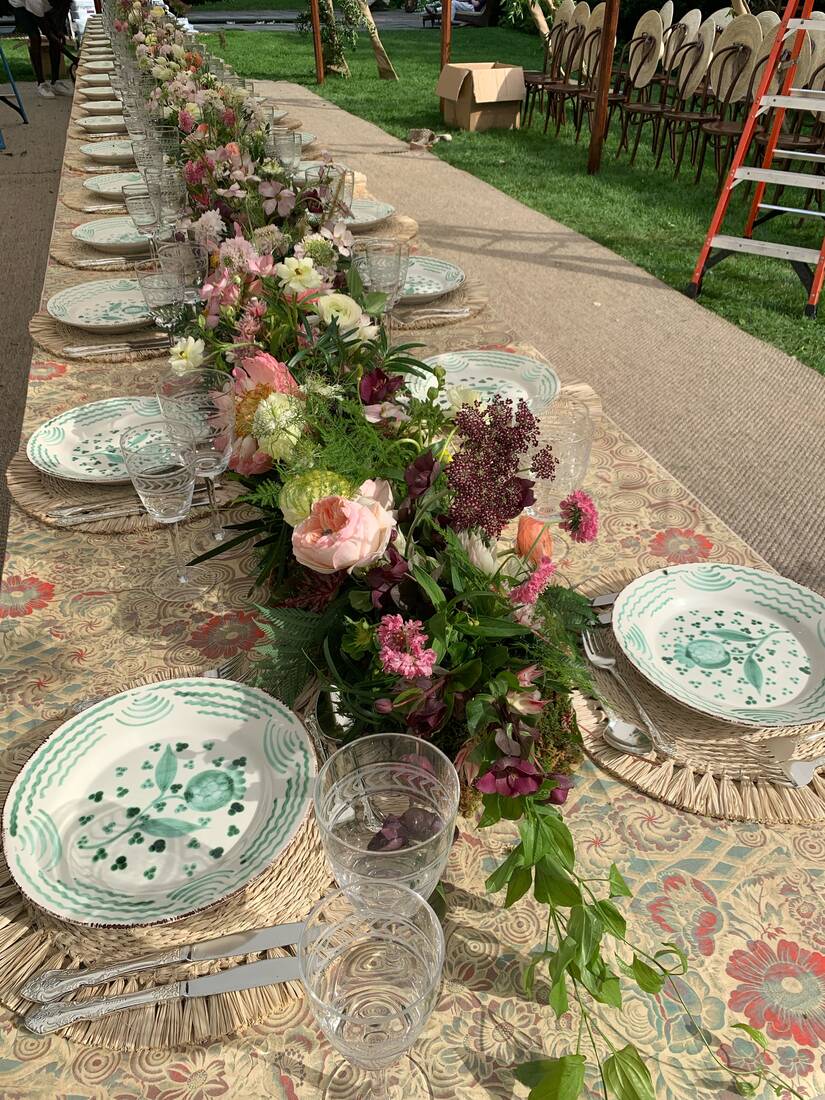 Long garden table with a continuous floral runner in soft pinks and burgundy